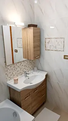 a bathroom with a sink and a mirror at Lumera in Santa Flavia