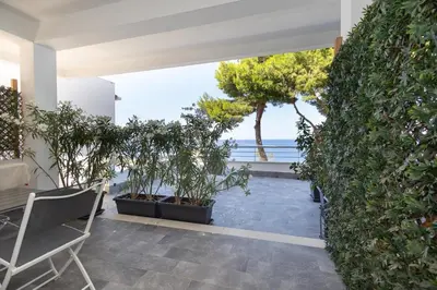 a living room with a view of the ocean at Mondello Addaura Addisio Suite in Palermo