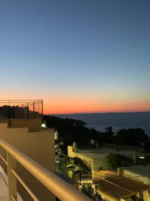 a view of the ocean from a balcony at sunset at Mondello Addaura Addisio Suite in Palermo