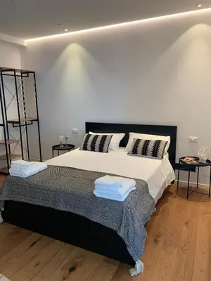 a bedroom with a large bed with two pillows at Mondello Addaura Addisio Suite in Palermo