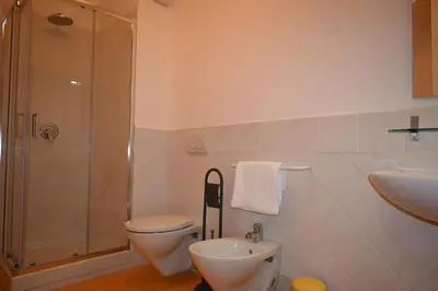 a bathroom with a toilet and a shower and a sink at Chalet Calarossa in Terrasini