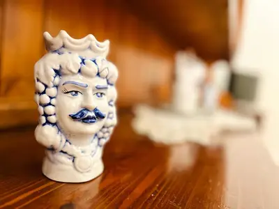 a statuette of a head on a wooden table at Nonna Sasà in Torretta