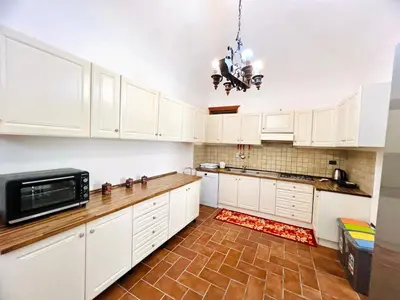 a kitchen with white cabinets and a microwave at Nonna Sasà in Torretta