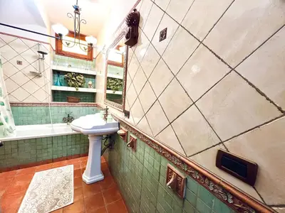 a bathroom with a sink and a bath tub at Nonna Sasà in Torretta