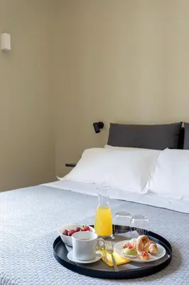 a tray of food with a breakfast on a bed at Mori's Rooms in Palermo