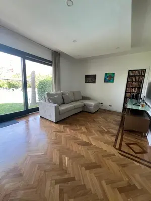 a living room with a couch and a wooden floor at Villa Losanna in Mondello