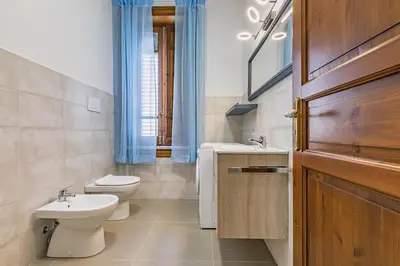 a bathroom with a toilet and a sink at GuestHost - Terry's Garden in Palermo in Palermo