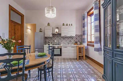 a kitchen with a table and a dining room at GuestHost - Terry's Garden in Palermo in Palermo