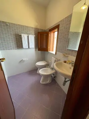 a bathroom with a toilet and a sink at Appartamento L'Agnuni in Castellammare del Golfo