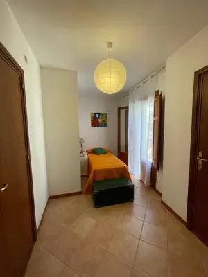 a bedroom with a bed in the middle of a room at Appartamento L'Agnuni in Castellammare del Golfo