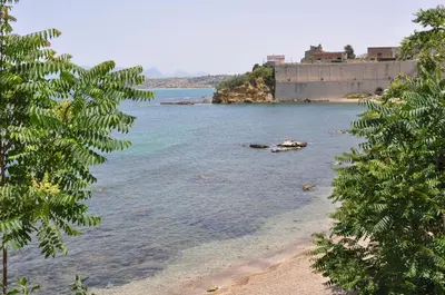 a view of a body of water with trees at Appartamento L'Agnuni in Castellammare del Golfo