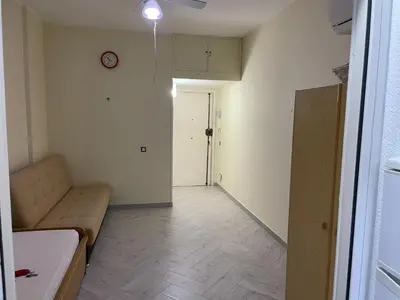 a living room with a couch and a clock on the wall at Residence _Capo Gallo in Palermo