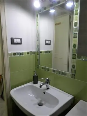 a bathroom with a sink and a mirror at Residence _Capo Gallo in Palermo