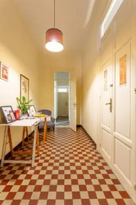 a living room with a checkered floor and a table at Nowhere Rooms in Palermo