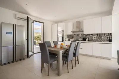 a kitchen and dining room with a table and chairs at Grande Villa privata con piscina a Scopello in Castellammare del Golfo