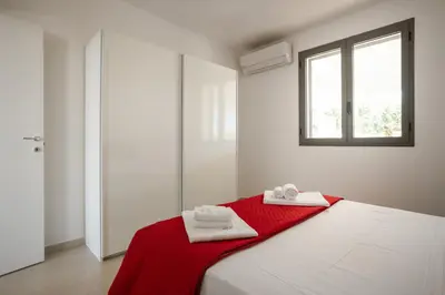 a bedroom with a bed with two towels on it at Grande Villa privata con piscina a Scopello in Castellammare del Golfo