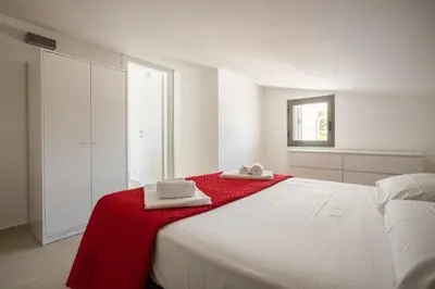 a bedroom with a large white bed with towels on it at Grande Villa privata con piscina a Scopello in Castellammare del Golfo
