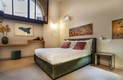 a bedroom with a large bed in a room at Isula in Palermo