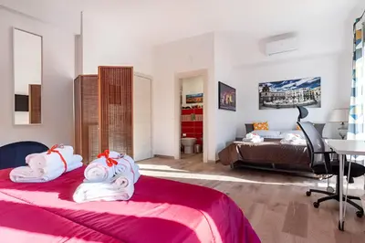 a yellow bedroom with a bed with two lamps at Ai Tesori di Palermo in Palermo