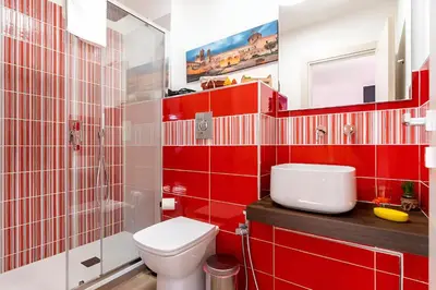 a room with two white chairs on a red bed at Ai Tesori di Palermo in Palermo