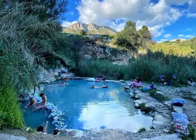 a group of people swimming in a pool of water at A Petrazzi in Castellammare del Golfo