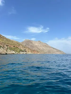 a large body of water with a mountain in the background at A Petrazzi in Castellammare del Golfo
