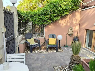 a patio with two chairs and a table at Casabella Mondello in Mondello
