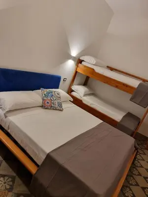 a room with two bunk beds and a couch at Domus Sant'Anna Apartment in Palermo