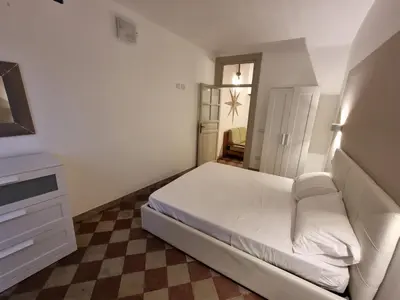 a small bedroom with a bed and a dresser at Domus Sant'Anna Apartment in Palermo