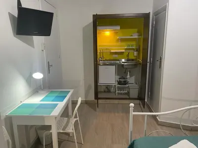 a small kitchen with a table and a dining room at Casa Vittoria in Palermo
