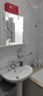a bathroom with a white sink and a mirror at Casa Zibè in Isola delle Femmine