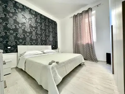 a bedroom with a bed and a black and white wall at Casa Pascal in Palermo