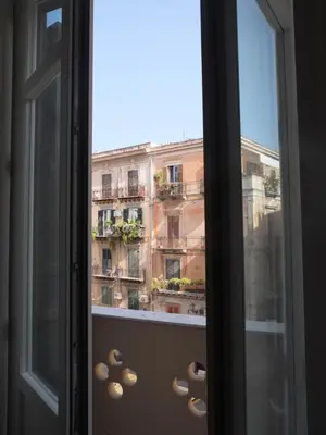 a window with a view of a building at Dimora Lecerf in Palermo