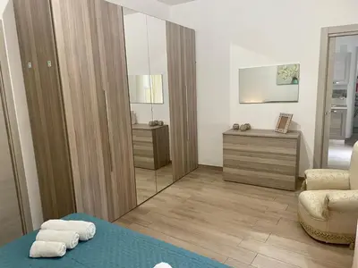 a corner of a room with a green bed at Maqueda Apartament for 4 Palermo Centre Ballarò in Palermo