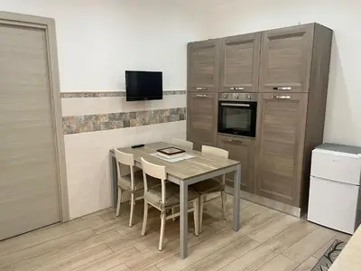 a cupboard with plates and dishes in a kitchen at Maqueda Apartament for 4 Palermo Centre Ballarò in Palermo