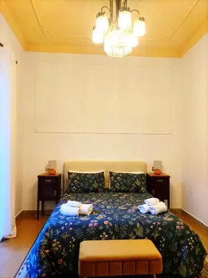 a bedroom with a bed with two pillows at AUSA suites in Palermo