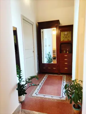 a hallway with a door and plants in a room at AUSA suites in Palermo