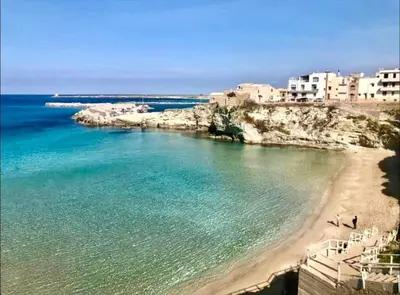 a view of a beach with buildings in the background at Katy's Holiday House, Private Villa and Pool in Terrasini