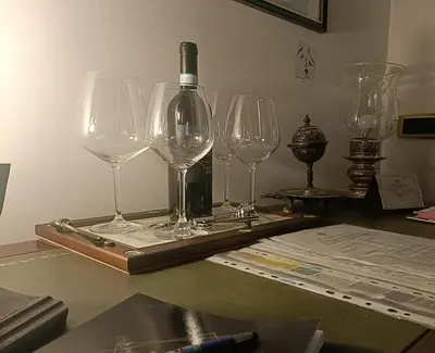 a tray with wine glasses and a bottle on a table at onoratocinque house apartment in Palermo