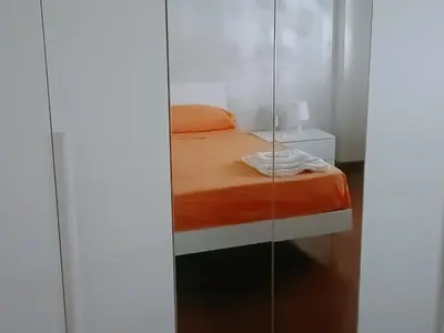 a bedroom with a bed and a glass wall at onoratocinque house apartment in Palermo