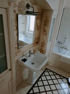 a bathroom with a sink and a mirror and a tub at onoratocinque house apartment in Palermo