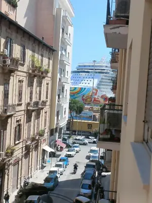 a city street with a cruise ship in the distance at onoratocinque house apartment in Palermo