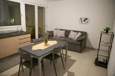 a living room with a table and a couch at Casa d'a-mare in Terrasini