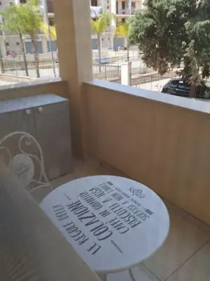 a white table with a sign on it on a balcony at Casa d'a-mare in Terrasini