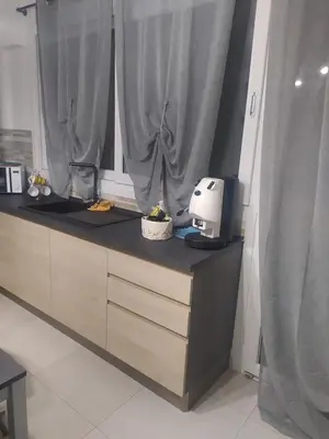 a kitchen with a counter with a printer and a window at Casa d'a-mare in Terrasini