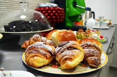 a plate of pastries and croissants on a table at B&B Casa Canali in Palermo
