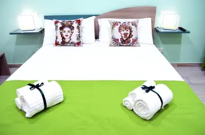 a bedroom with two towels on a bed at B&B Casa Canali in Palermo