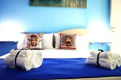 a blue bedroom with a bed with towels on it at B&B Casa Canali in Palermo