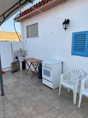 a kitchen with a stove and a table and chairs at Casa Scirocco in Balestrate