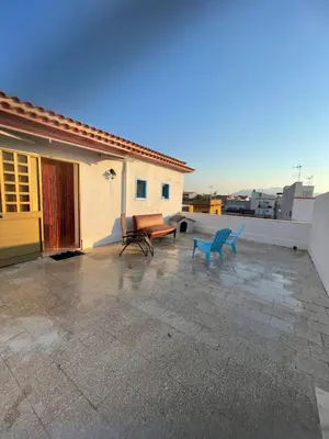 a patio with two blue benches on a house at Casa Scirocco in Balestrate